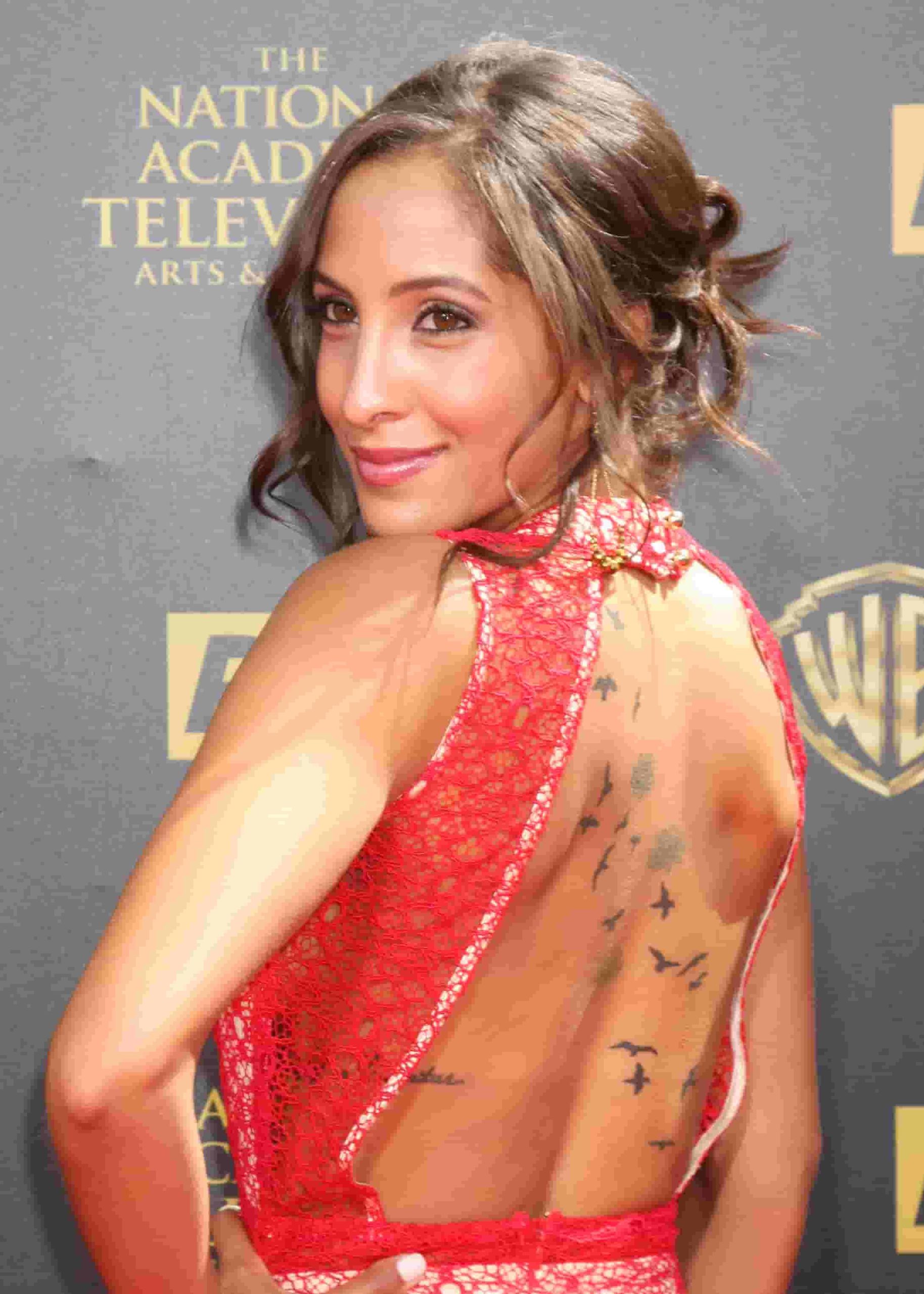 Image of Christel Khalil with back tattoos